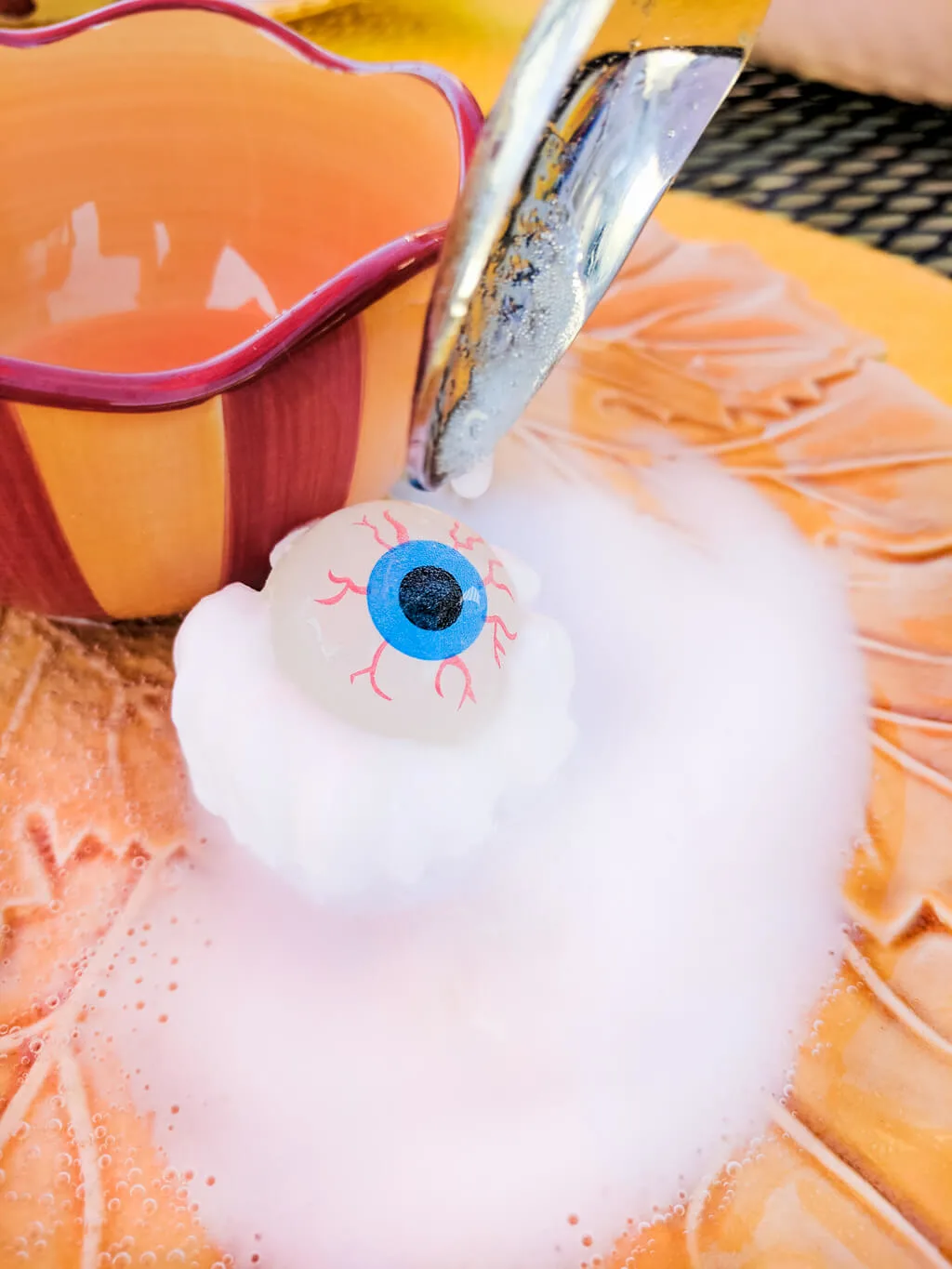 Fun kids Halloween party game: Eyeball surprise! Freeze glow-in-the-dark eyeball bouncy balls in baking soda and water, then spoon on vinegar to reveal. #halloween #halloweenparty