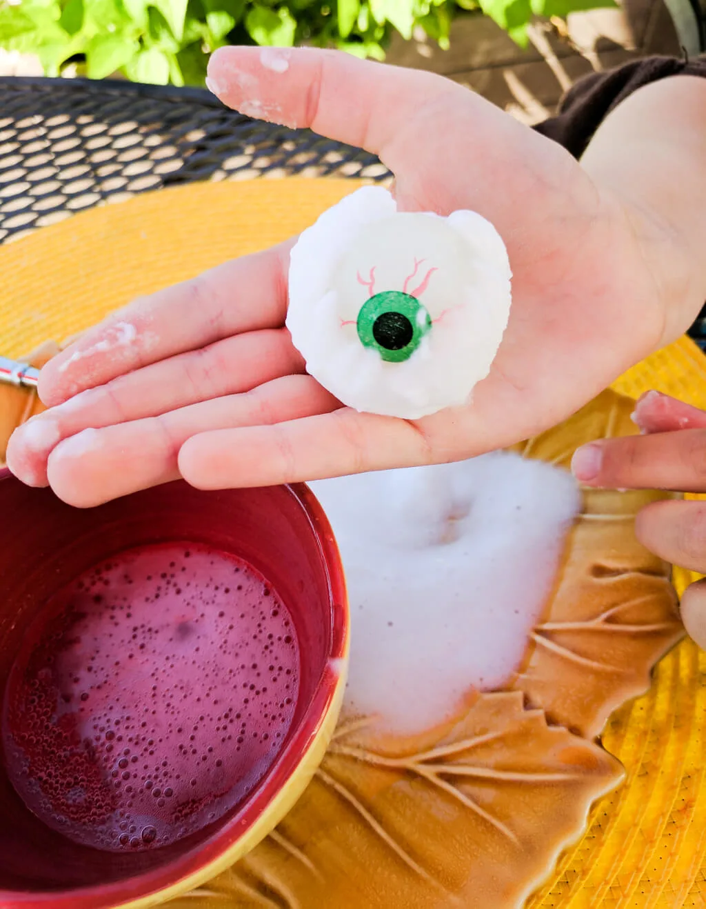 Fun kids Halloween party game: Eyeball surprise! Freeze glow-in-the-dark eyeball bouncy balls in baking soda and water, then spoon on vinegar to reveal.