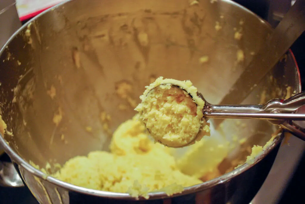 Scooping cookie dough with an ice cream scooper