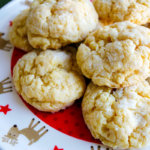 Ooey gooey butter cookies recipe - you'll never guess that these delicious cookies come from a yellow cake mix! Make these St. Louis quick and easy cake mix cookies from scratch for Christmas cookie exchanges and school celebrations. #ooey #gooey #butter #cookies #recipe #cake #mix #easy #yellow #christmas #scratch