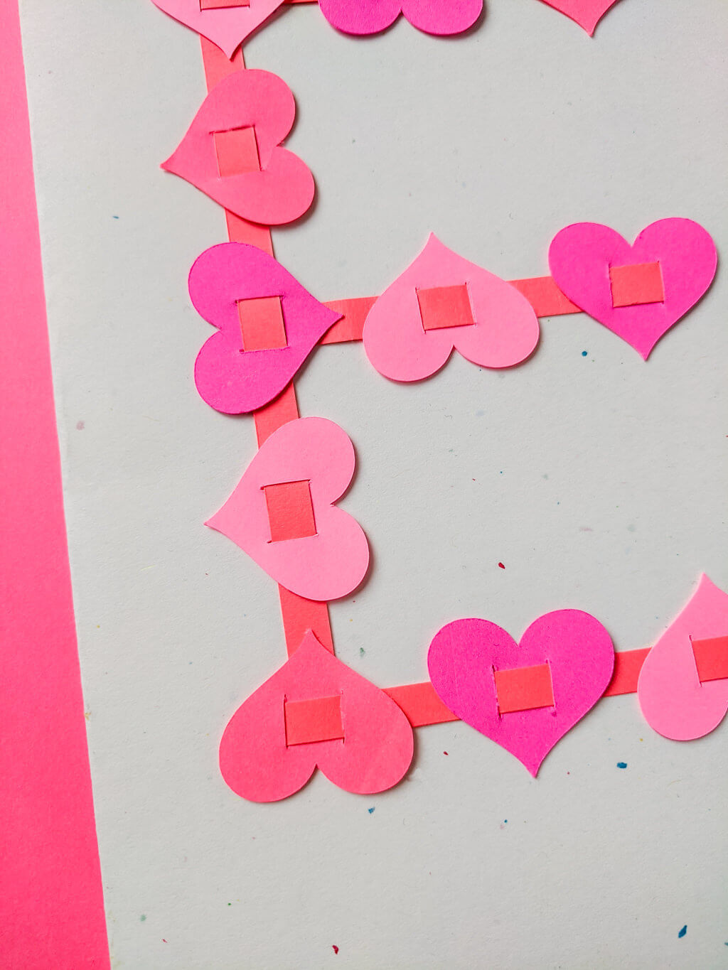 Paper hearts woven on paper strips