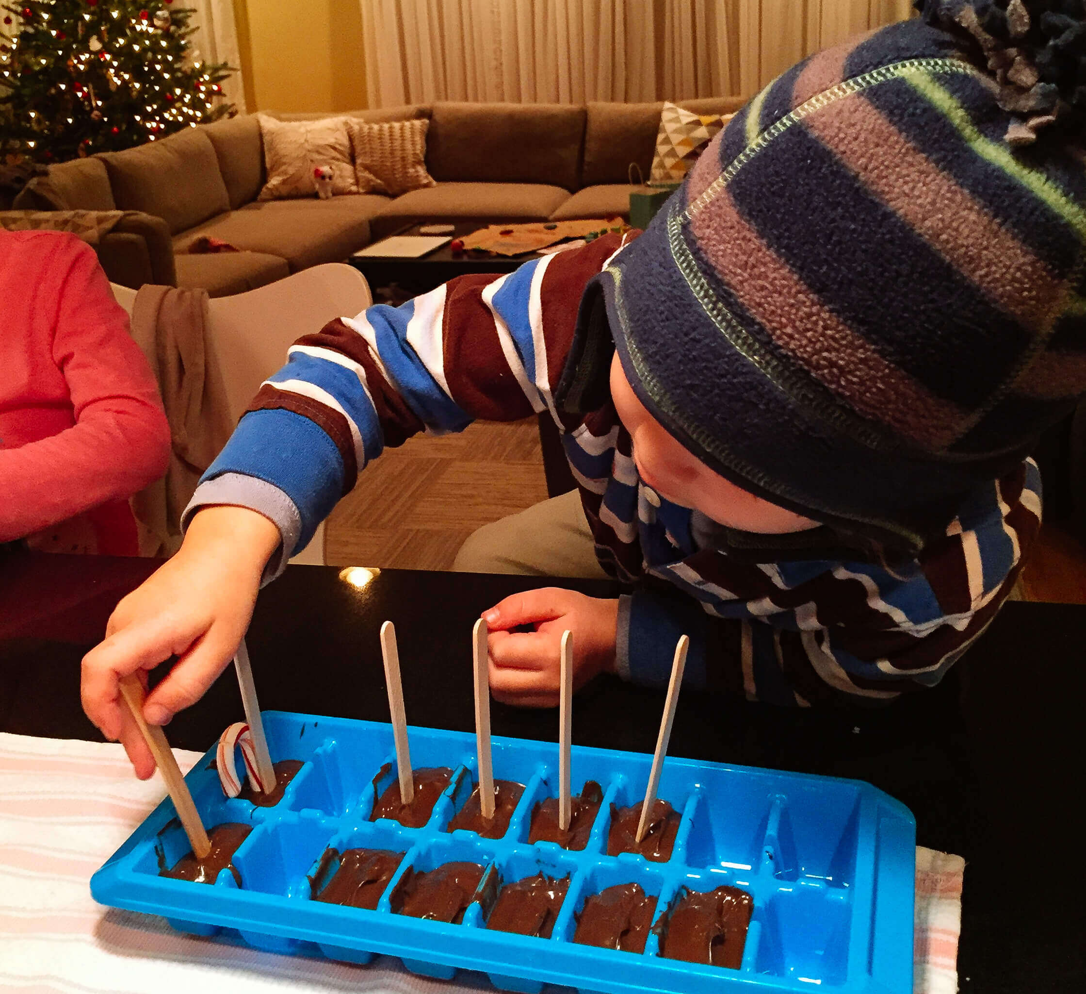 Liam making chocolate stir sticks. Copyright Merriment Design Co.