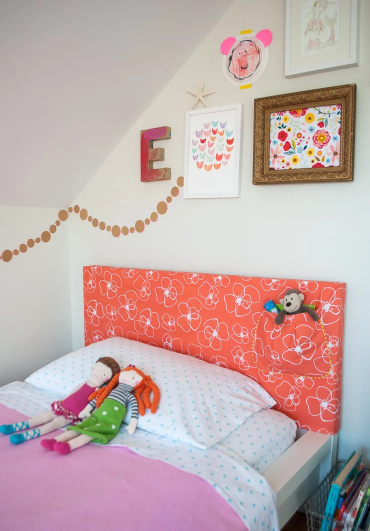 How to make a DIY headboard slipcover with a super cute storage pocket. What a cute way to temporarily update a bedroom! You can hack an IKEA Malm bed or make the slipcover for your own headboard!