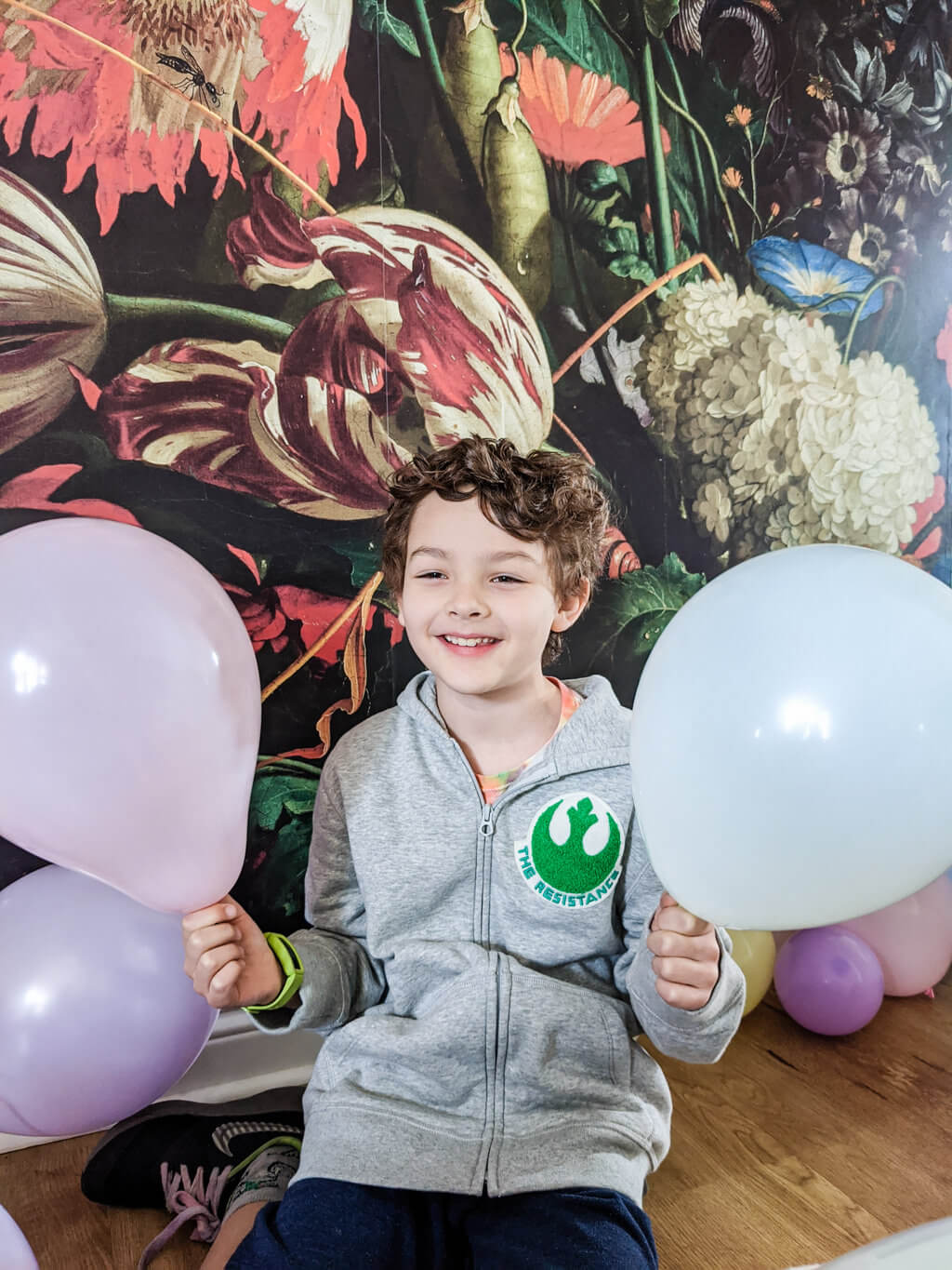 Liam holding balloons for a balloon garland - photo copyright Merriment Design Co.