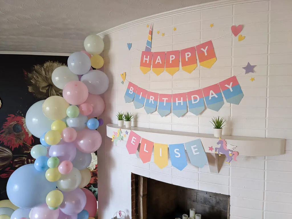 Rainbow unicorn pastel banner with unicorn horn and balloon garland