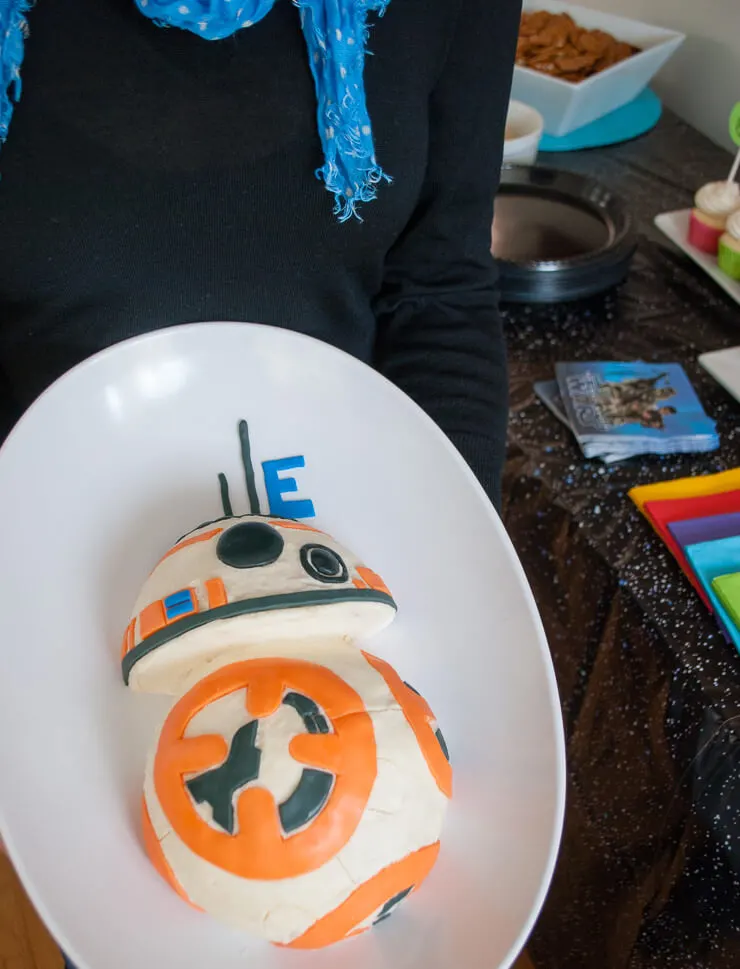 Holding DIY Star Wars birthday cake - BB-8