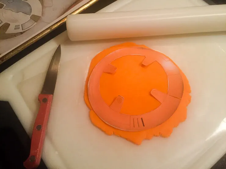 Cutting fondant for a BB-8 cake