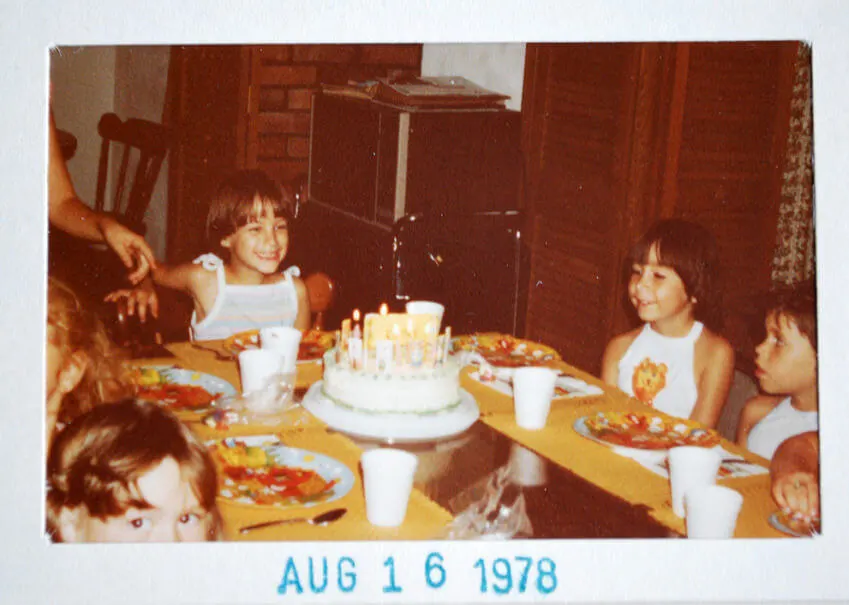 1970s girls birthday party with cake and candles