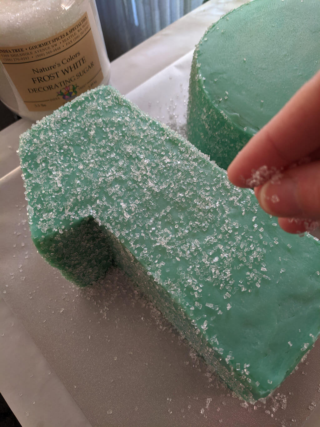 Adding sanding sugar to a 10th birthday cake