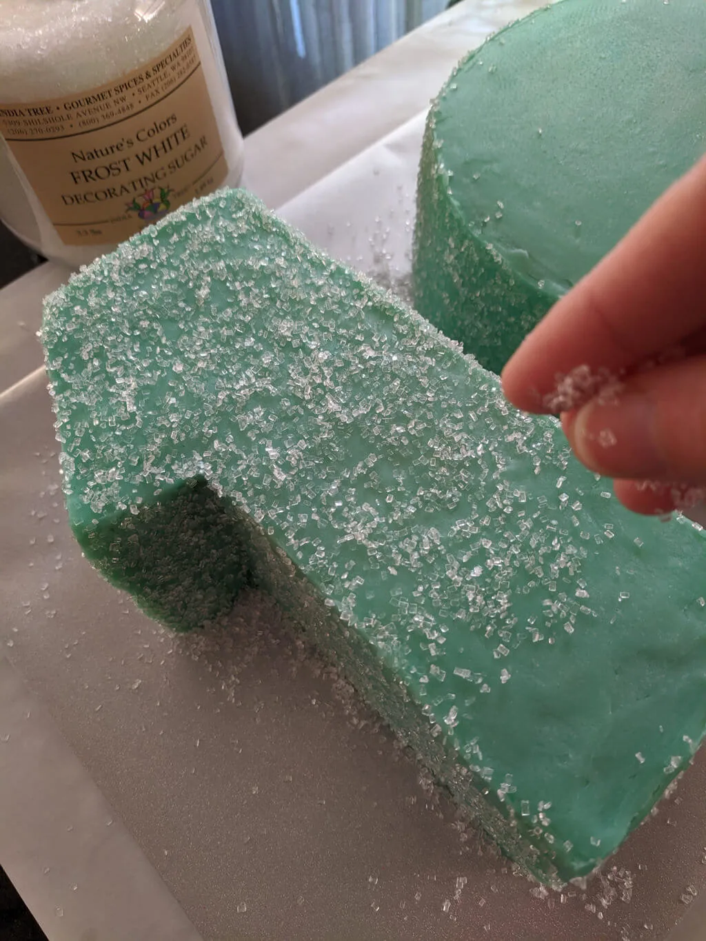 How to add sanding sugar to a 10th birthday cake. See the best sanding sugar to use to decorate birthday cakes with sanding sugar, and I'll show you how to put sanding sugar on a birthday cake with step-by-step photos and images. #sanding #sugar #birthday #cake #decorate Adding sanding sugar to a 10th birthday cake