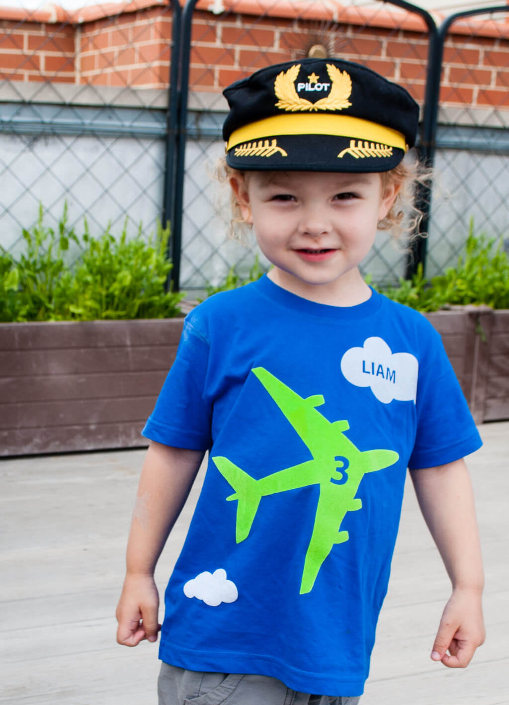 Kid's airplane birthday t-shirt personalized with name and age.