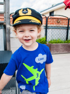 Kid's airplane birthday t-shirt personalized with name and age.