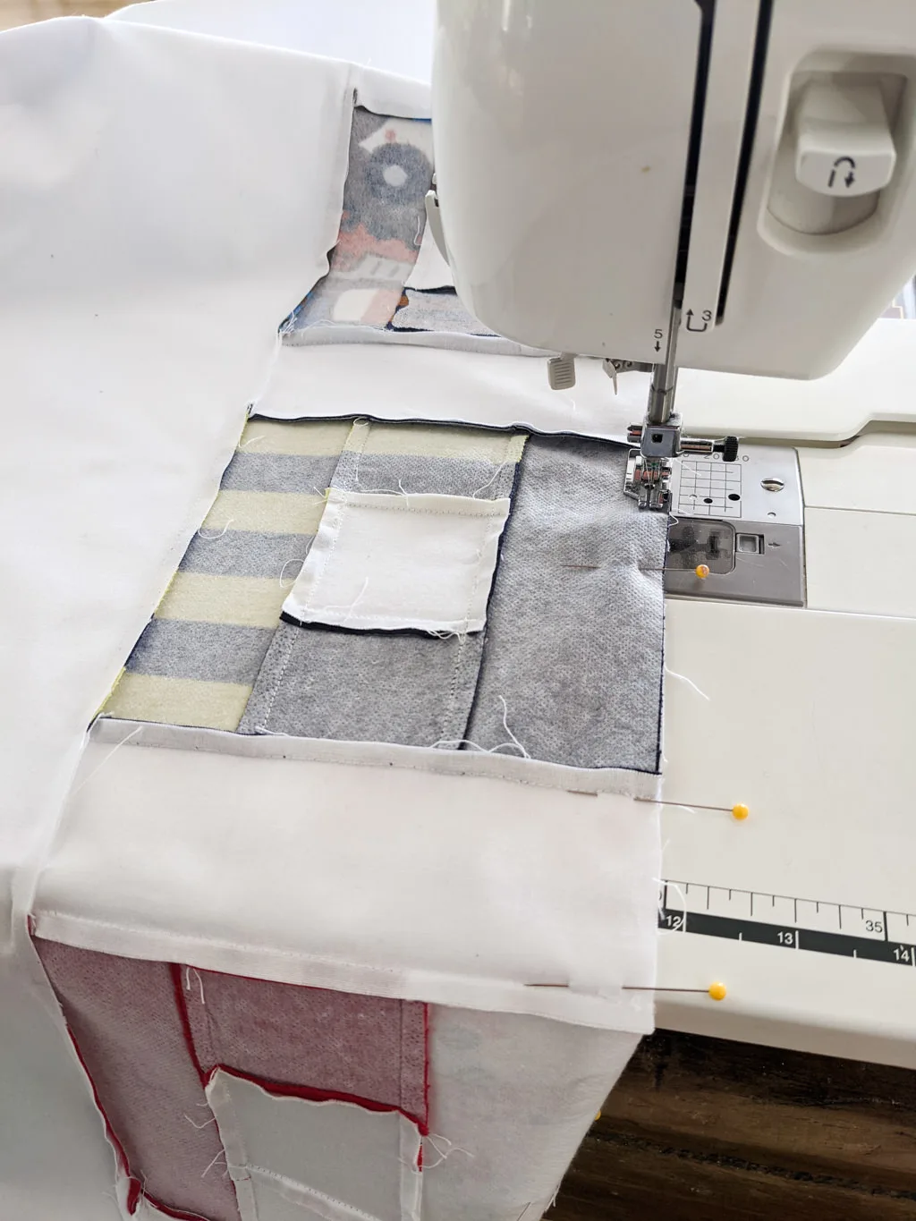 Sewing a DIY baby clothes keepsake quilt blanket