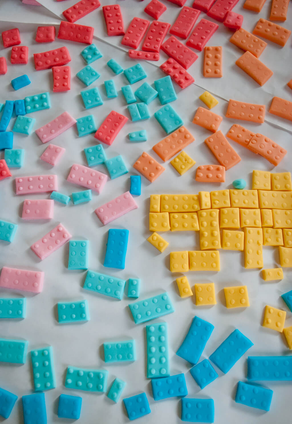 How to make thin fondant LEGO bricks for a LEGO Friends birthday cake. Making fondant LEGO blocks is easy and fun, even for beginner cake decorators. #legobirthday #cakes #birthdaycake #legocake #legos #legobirthdayideas