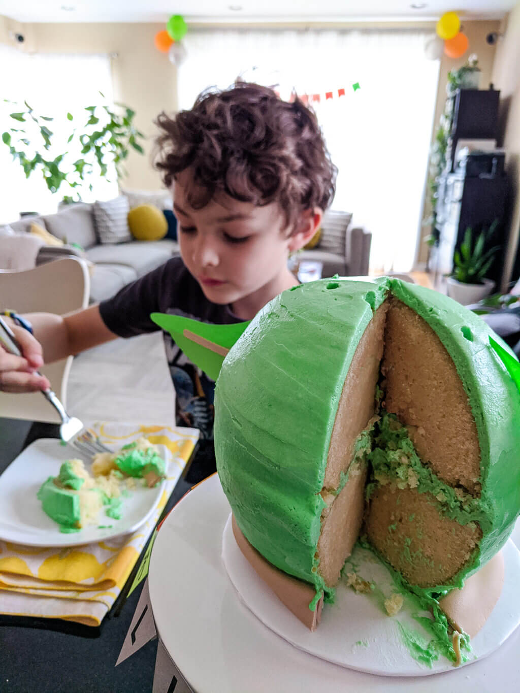 Liam eating a Mandalorian Baby Yoda birthday cake - Copyright Merriment Design Co. Do Not Distribute without written permission.