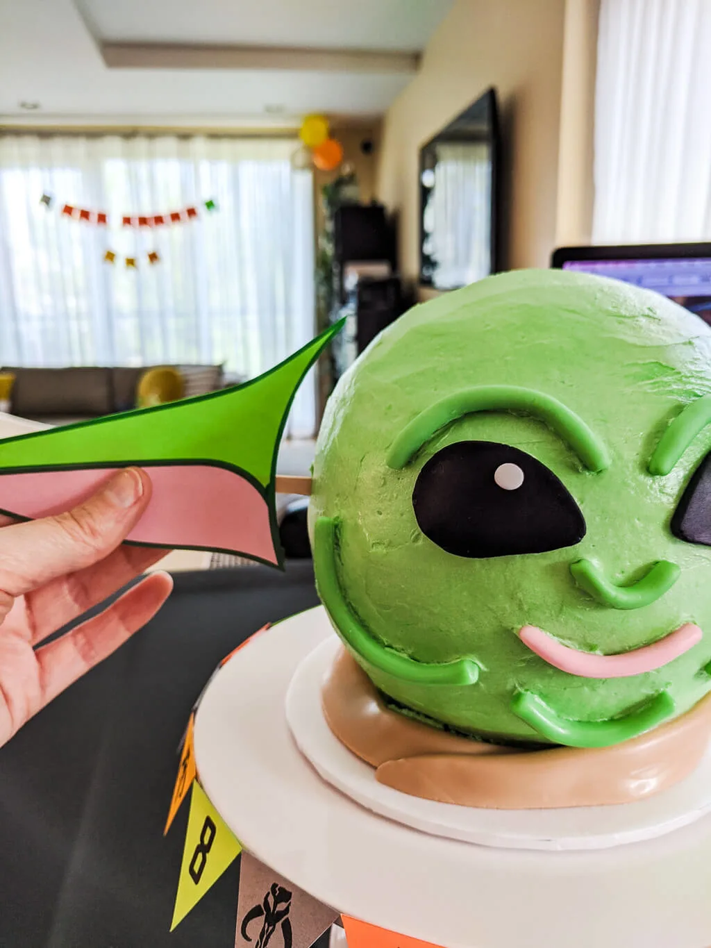 How to make a DIY Baby Yoda cake using printable Yoda ears Adding printable ears to a DIY Baby Yoda cake