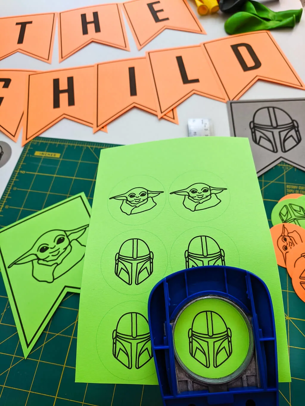 Paper Mandalorian cupcake toppers cut out with craft punch