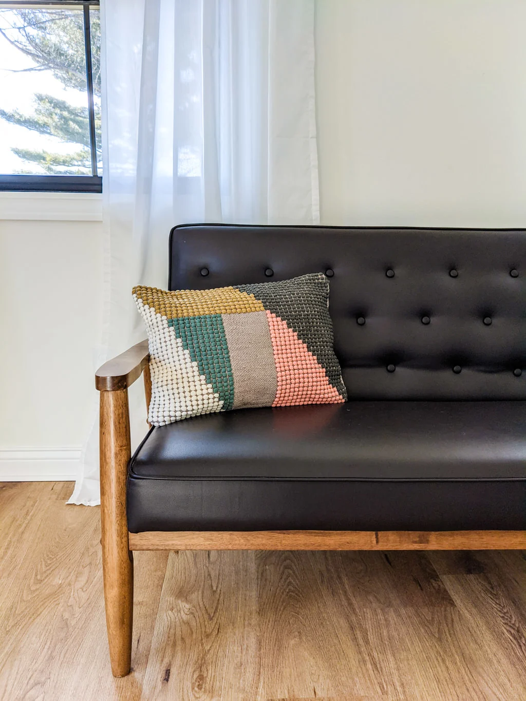 Mid-century modern pillow on black chair