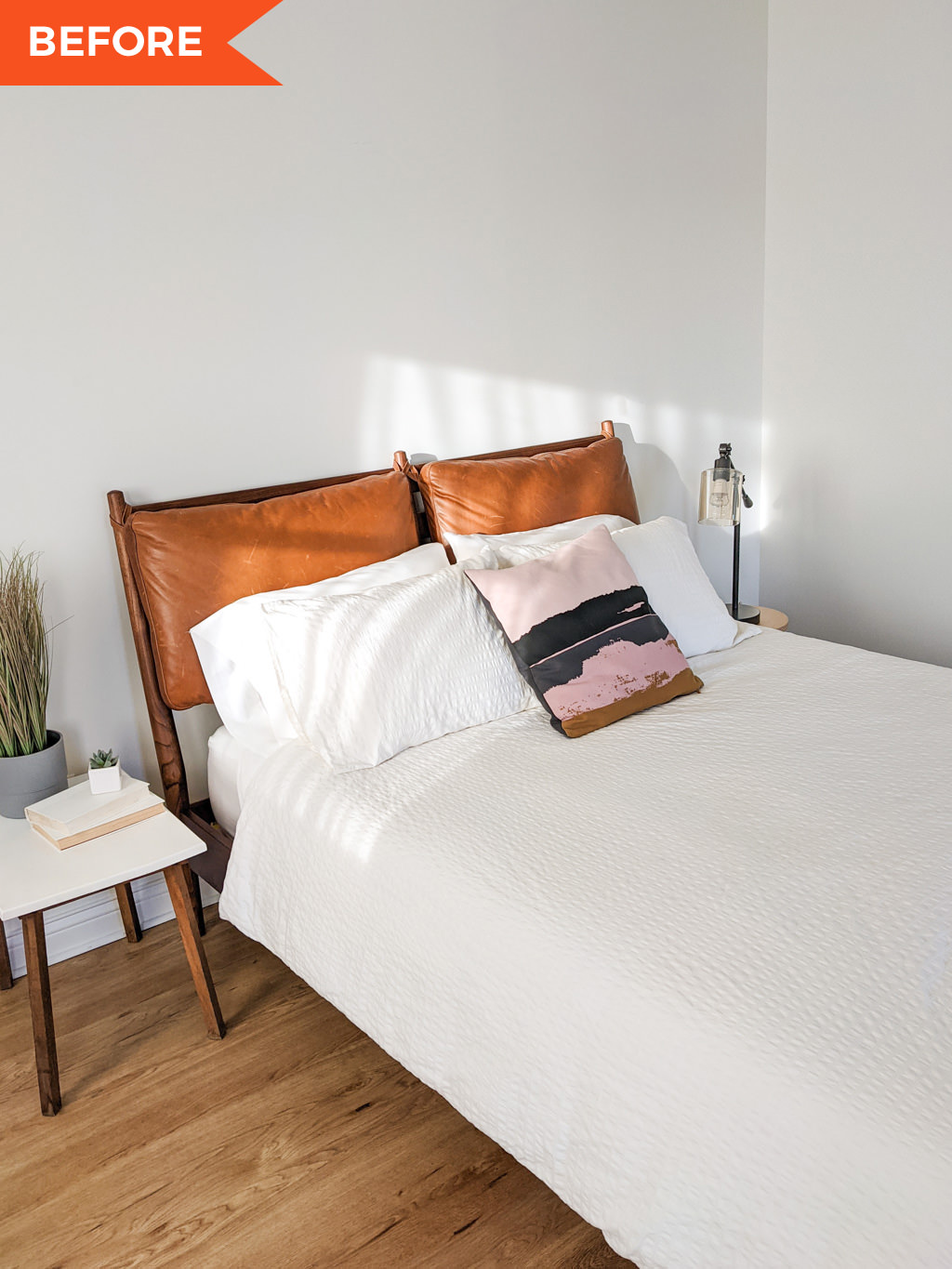 Leather headboard with white comforter in the bedroom