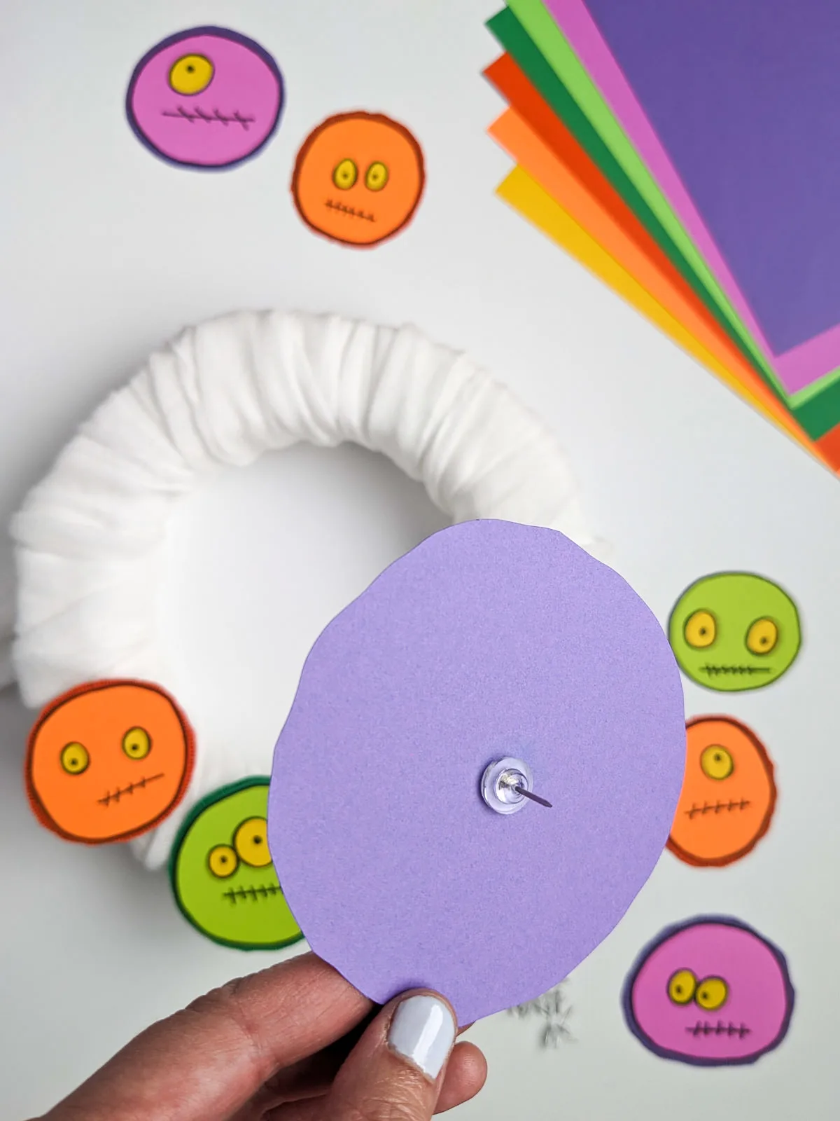 How to make a DIY Monster Wreath | Halloween Decorations for Your Door or Indoors How to attach monsters to a wreath covered in cheesecloth by using long push pins