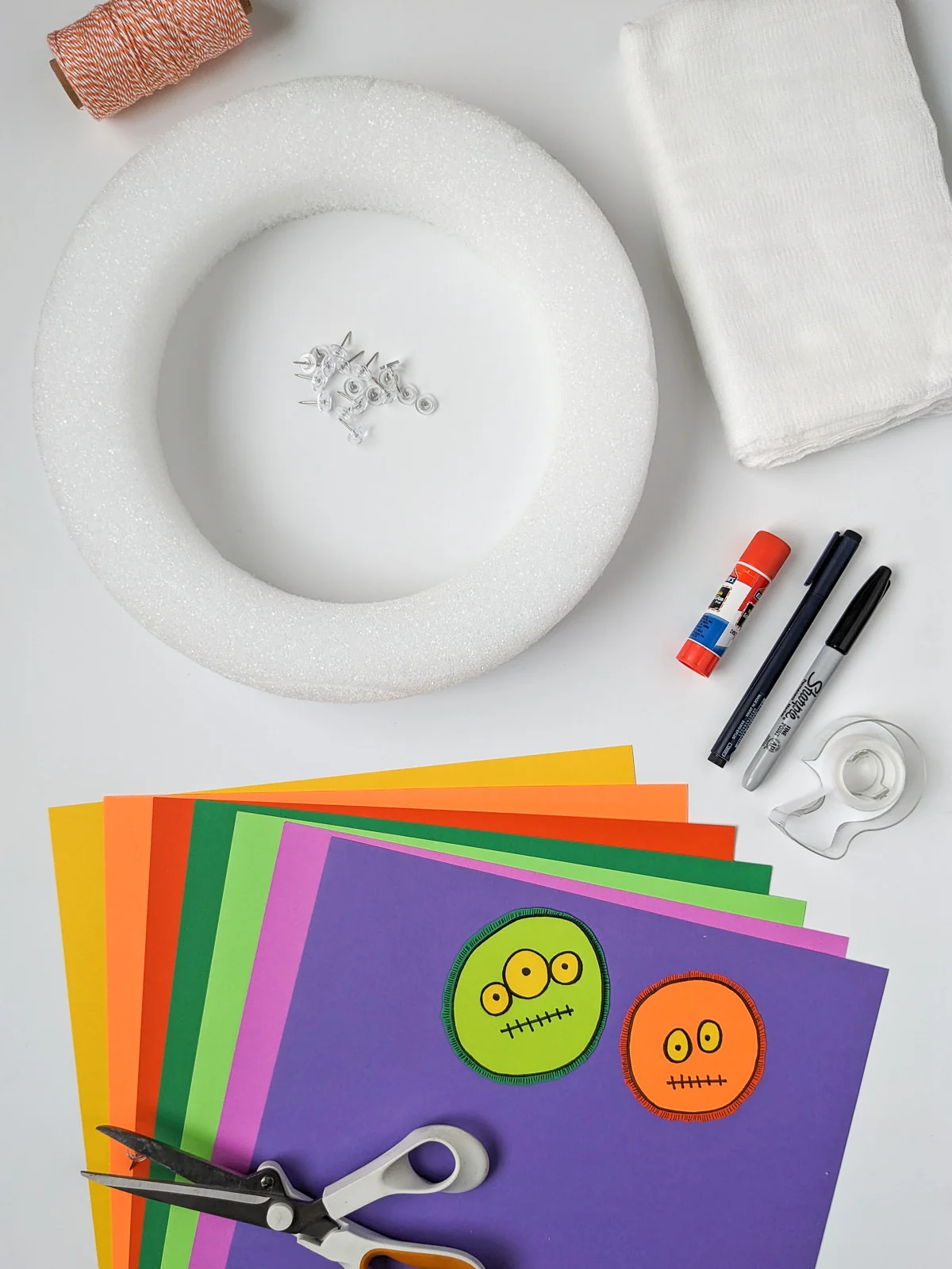 Craft supplies for making a DIY Halloween monster wreath Craft supplies for making a DIY Halloween monster wreath: Wreath form, paper, scissors, cheesecloth, push pins, glue stick
