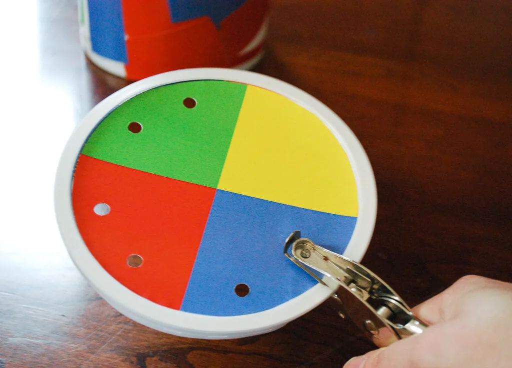 Punching holes in oatmeal container straw game