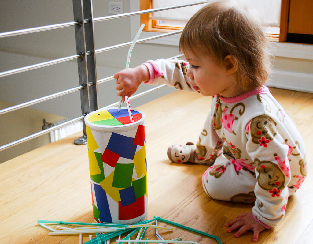 Playing with a DIY oatmeal container straw game