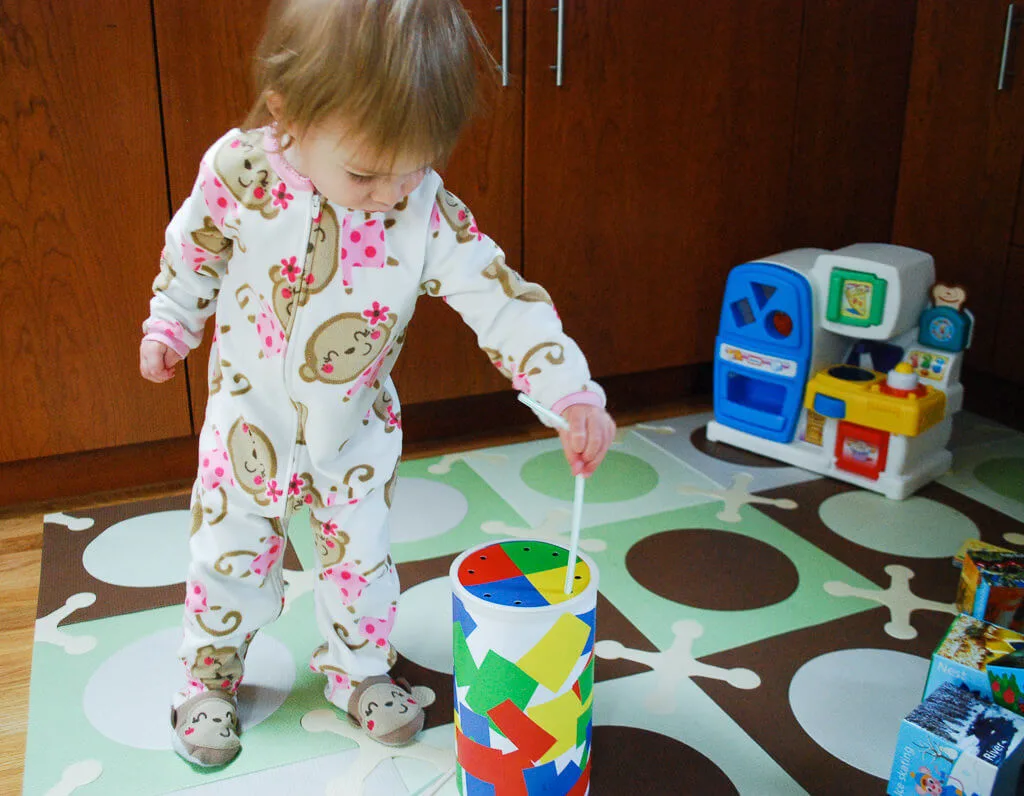 Playing with a DIY oatmeal container straw game