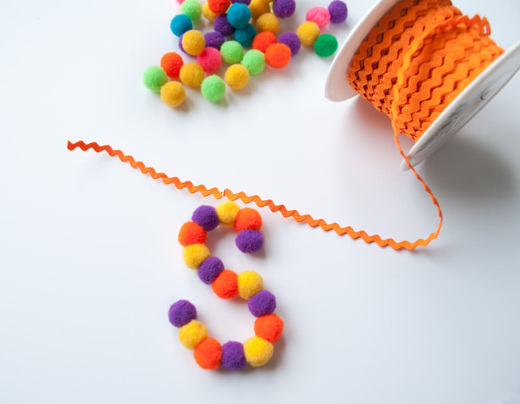 Making DIY pom pom letter Christmas ornaments