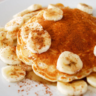 Rice pancakes on a plate with bananas and cinnamon