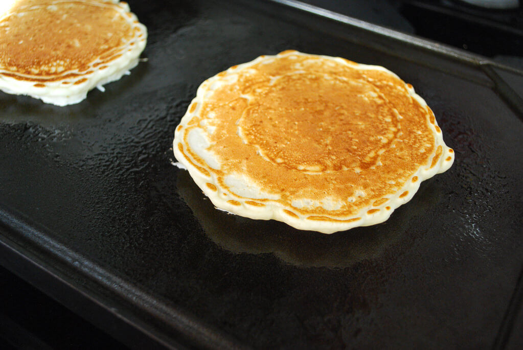 Rice pancakes cooking on a griddle