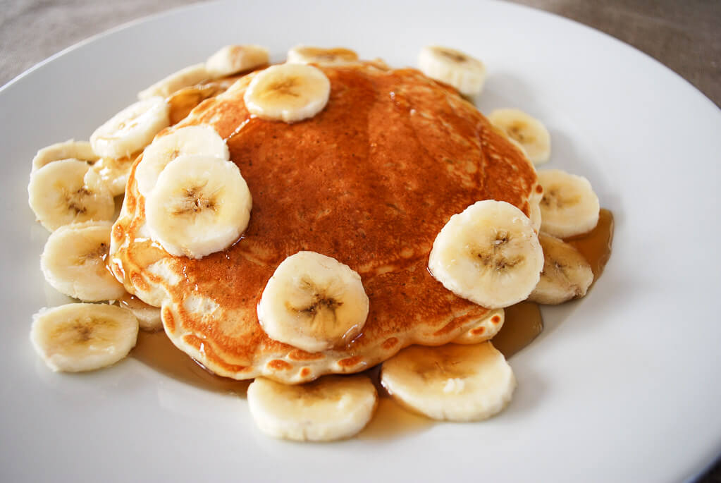 Rice pancakes on a plate with bananas and cinnamon