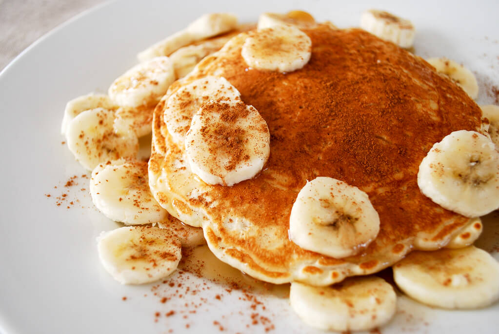 Rice pancakes on a plate with bananas and cinnamon