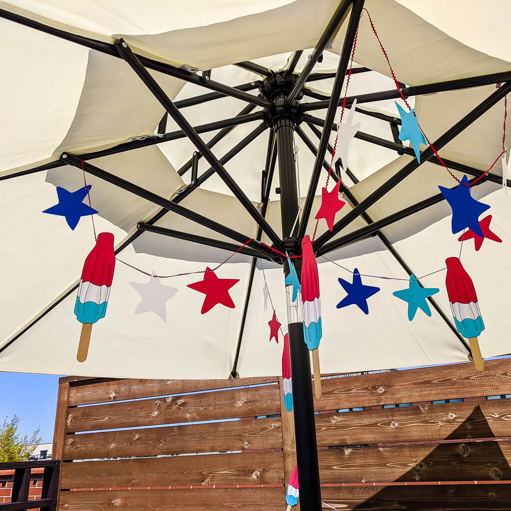 Fourth of July garland DIY hung inside a patio umbrella