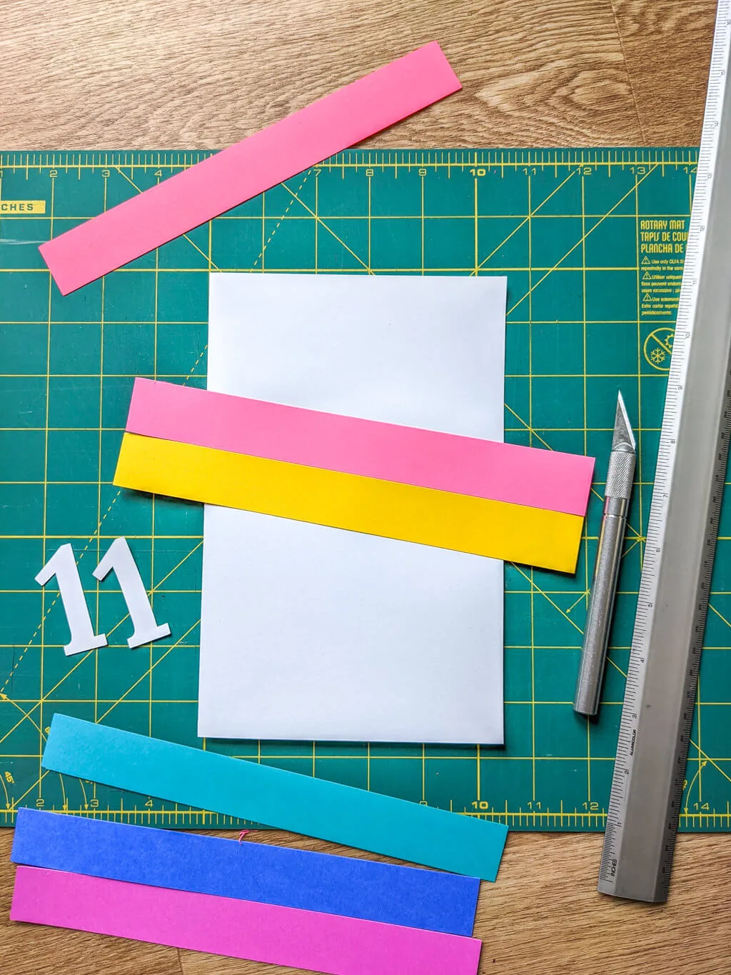 Gluing colored paper onto a white card to make a birthday card