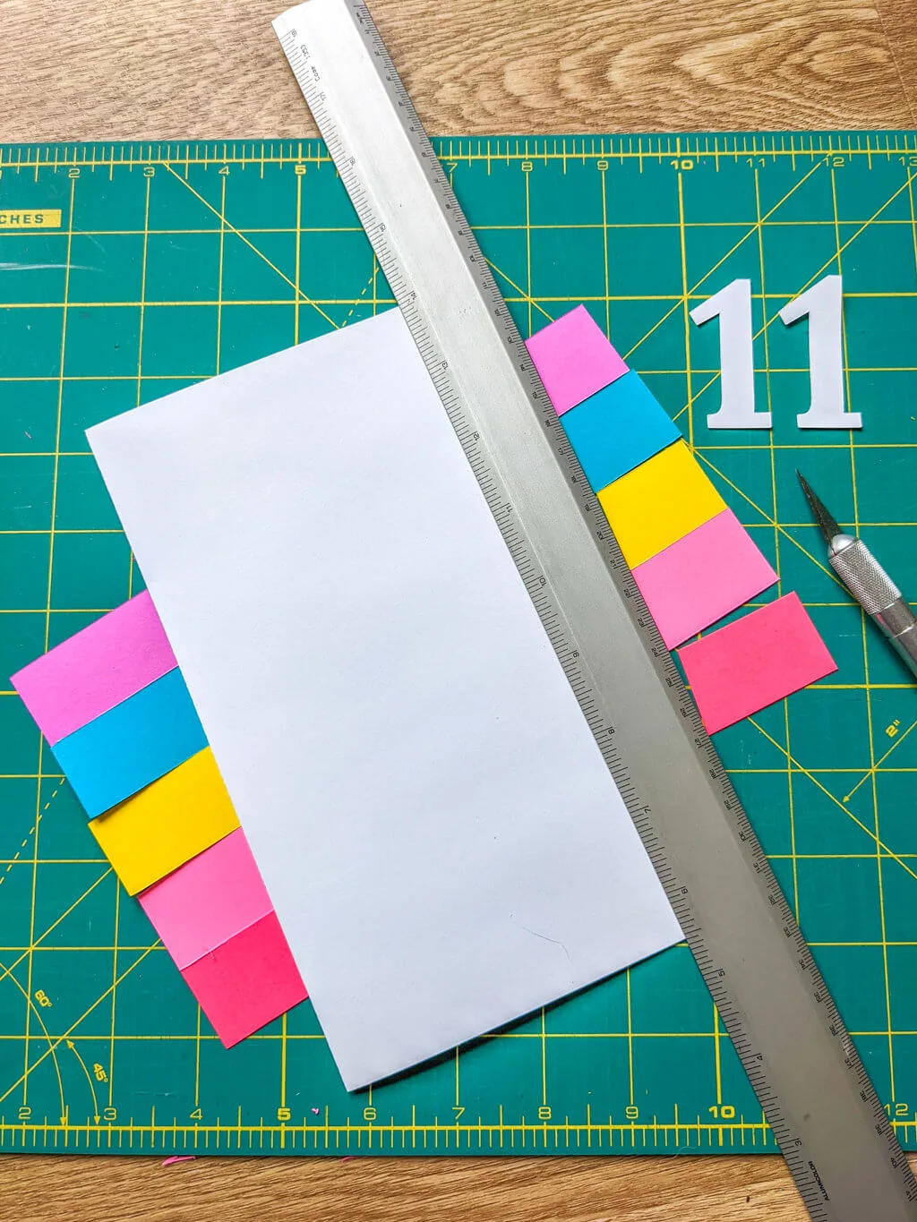Cutting paper to make a handmade rainbow birthday card