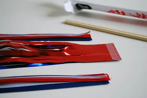 Merriment :: Sparkless sparklers for kids for the Fourth of July using chopsticks, ribbon and party garland free DIY tutorial craft project for Merriment Design by Kathy Beymer at MerrimentDesign.com