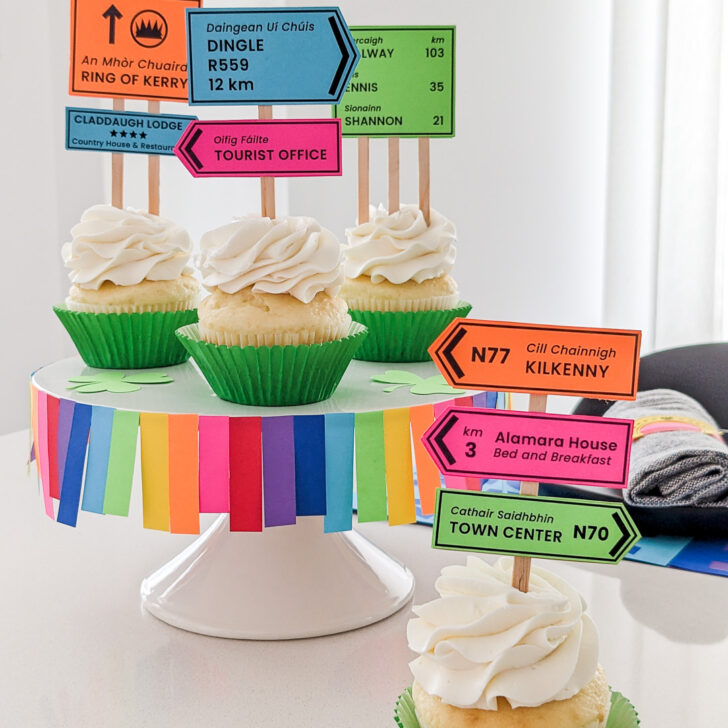 Irish road signs cupcakes sitting on a DIY rainbow cake stand for St. Patrick's Day