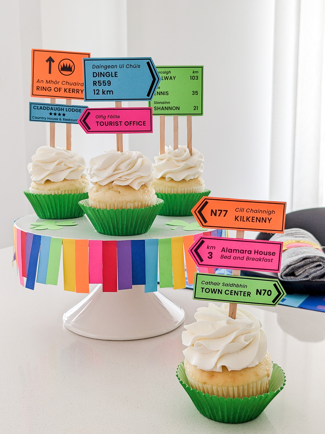 Irish road signs cupcakes sitting on a DIY rainbow cake stand for St. Patrick's Day