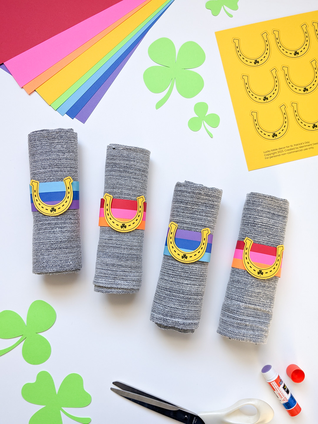 DIY St. Patrick's Day napkin rings craft with yellow horseshoes and rainbows