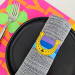 St. Patrick's Day paper napkin rings and placemats with horseshoes, rainbows, and shamrocks