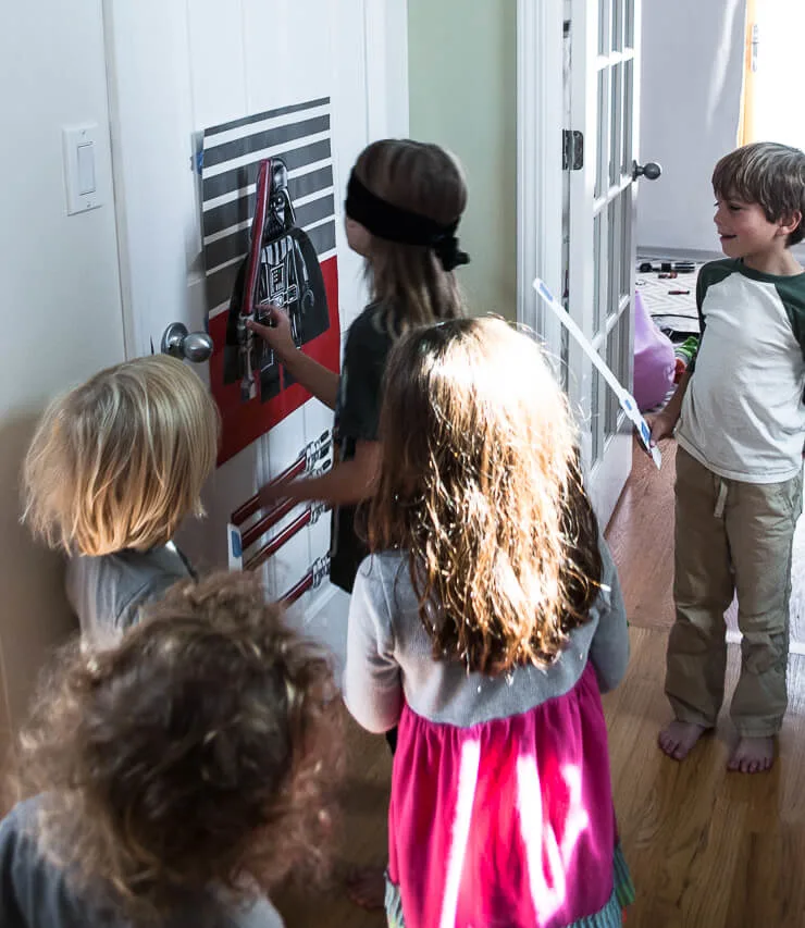 Make this easy and fun Star Wars DIY Birthday Party Game: Pin The Lightsaber On Darth Vader