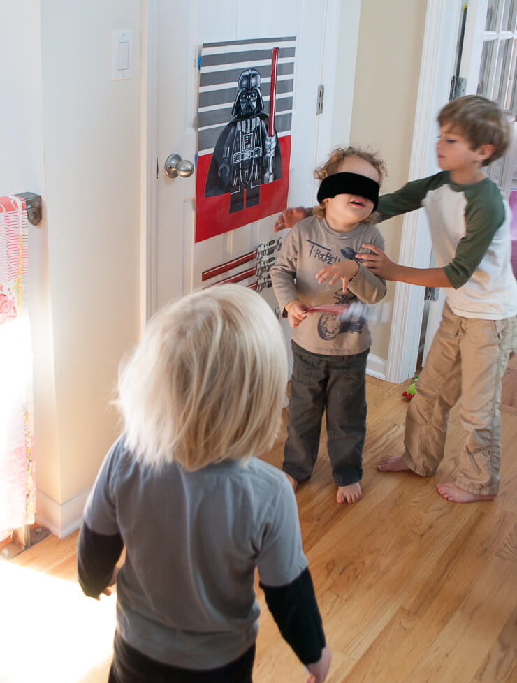 Make this easy and fun Star Wars DIY Birthday Party Game: Pin The Lightsaber On Darth Vader