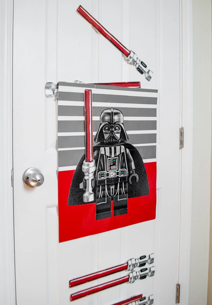 Make this easy and fun Star Wars DIY Birthday Party Game: Pin The Lightsaber On Darth Vader