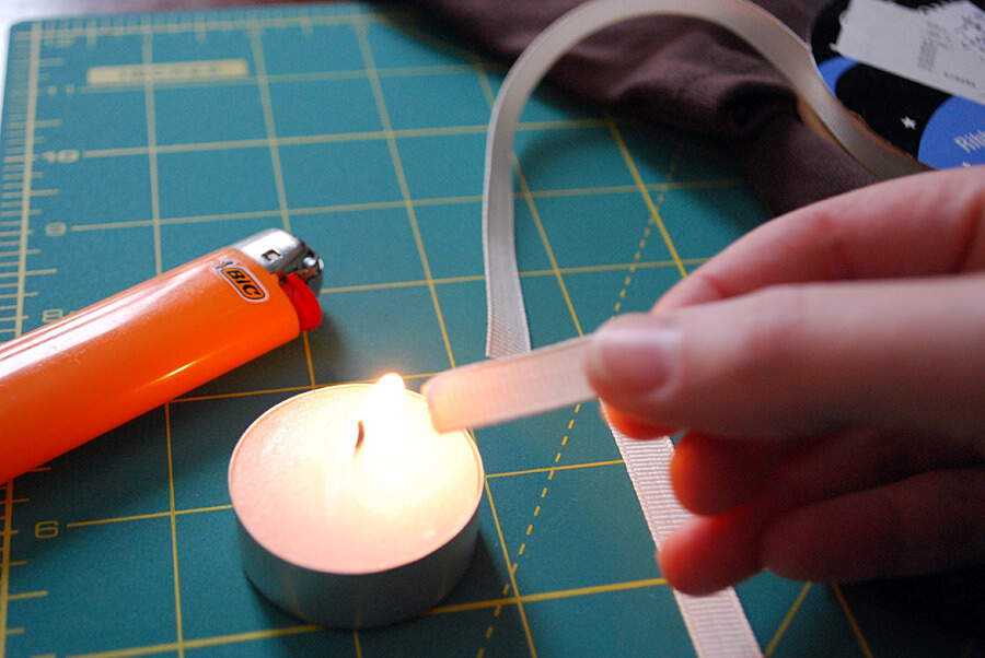 How to use a candle to keep grosgrain ribbon from raveling when making a DIY kids football t-shirt