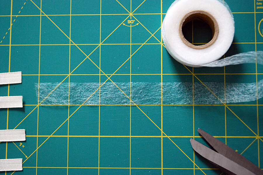 Use iron-on fusible web to adhere grosgrain ribbon to a DIY football t-shirt