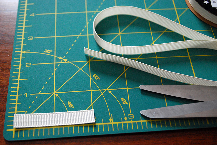 Cutting grosgrain ribbon to make a DIY kids' football t-shirt