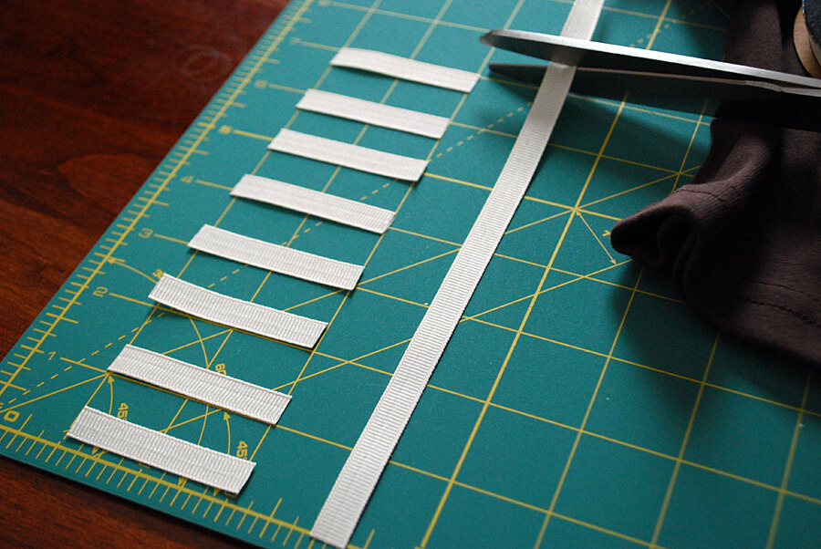 Cutting grosgrain ribbon to make a DIY kids' football t-shirt