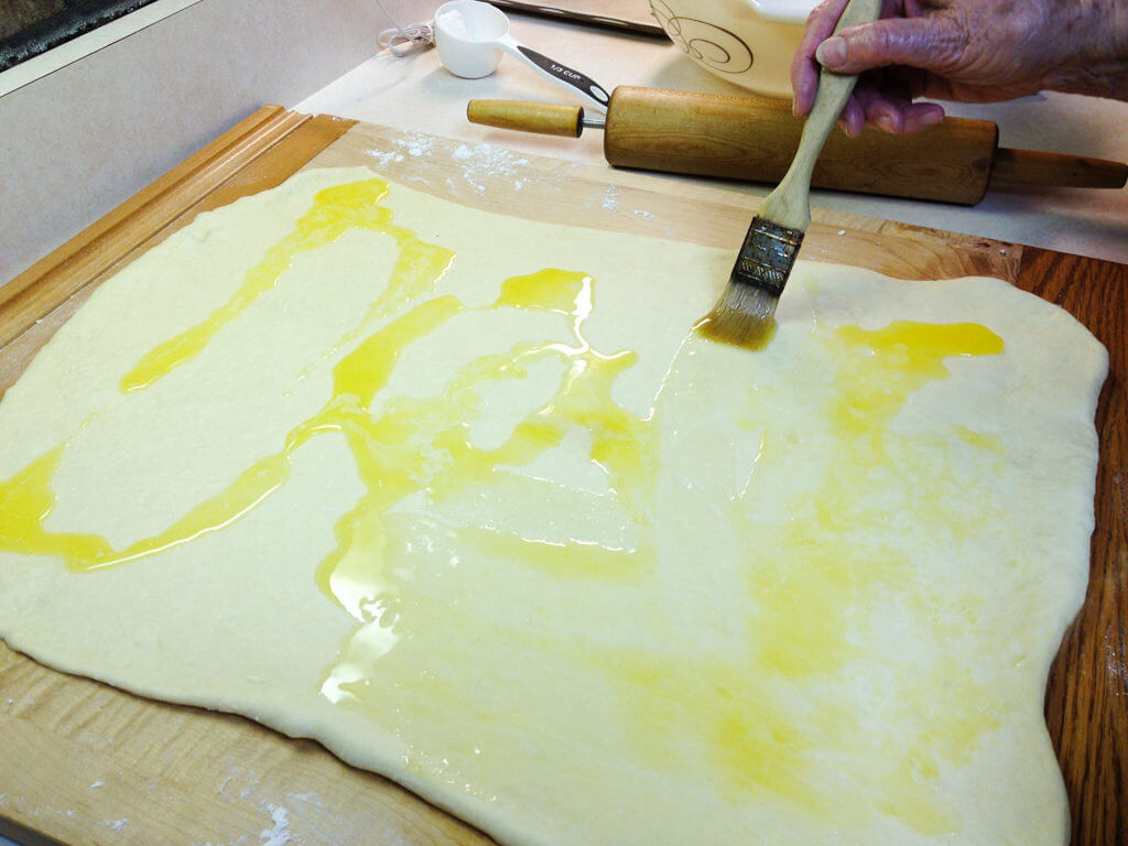 Brushing butter on Swedish Tea Ring dough