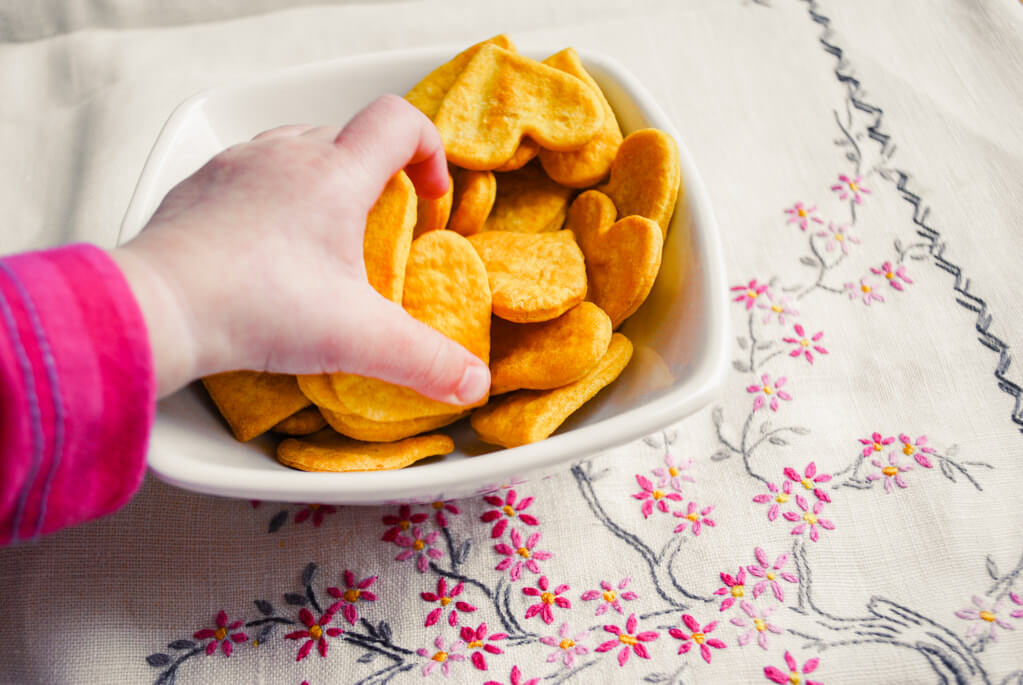 Kid grabbing potato crackers